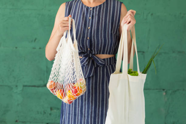 female holding goods in reusable bags