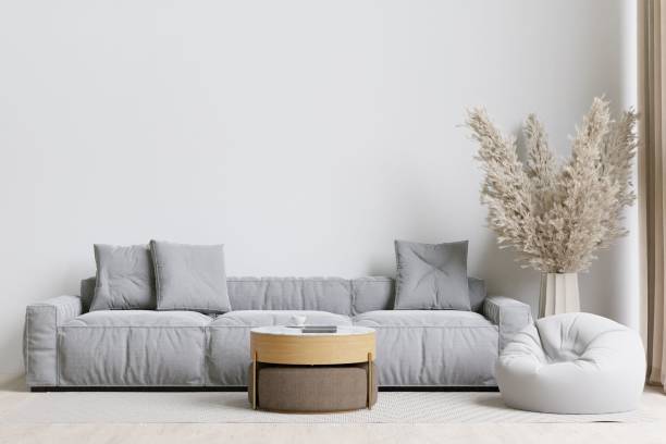 A contemporary living room with a grey sofa, bean bag, and coffee table