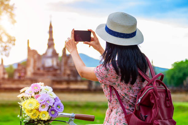 A lady on vacation taking a photo with her mobile phone