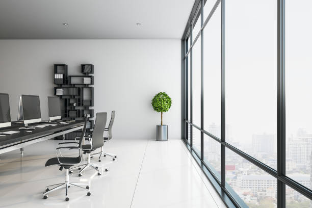 Modern green office interior with furniture, computer and window with panoramic city view.