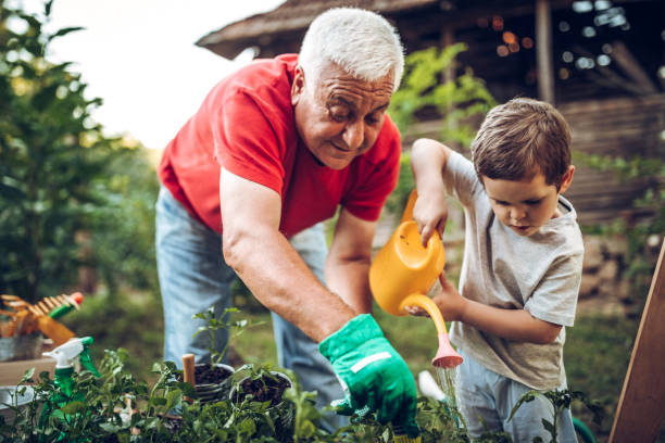 Grandfather and grandson playing in backyard with zero-waste gardening tools