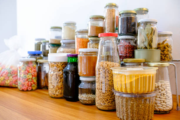 Complete pantry with several glass jars for food storage.