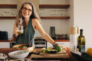 Mature woman serving herself wholesome vegan food at home in her sustainable kitchen.