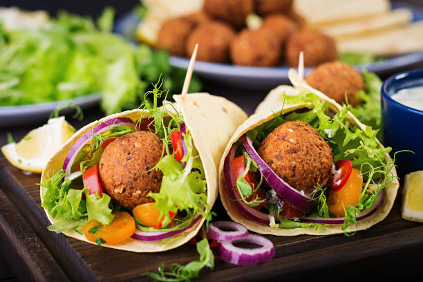 Tortilla wrap with falafel and fresh salad. Vegan tacos. Vegetarian healthy food.