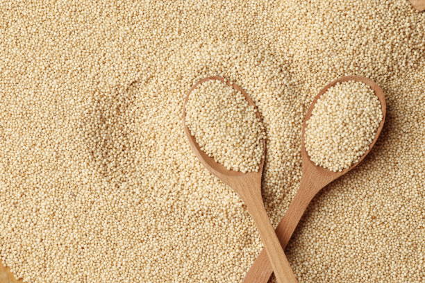 Amaranth in a wooden spoon on the background of porridge