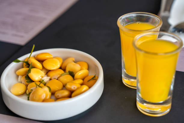 Yellow Lupin Beans with orange beverage, aperitif concept. 