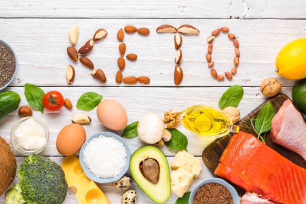 Keto vegan diet plan for weight loss. Balanced low-carb food background. Vegetables, fish, meat, cheese, nuts on wooden background.