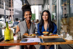 Businesswoman at lunch break enjoying a veggie burger.